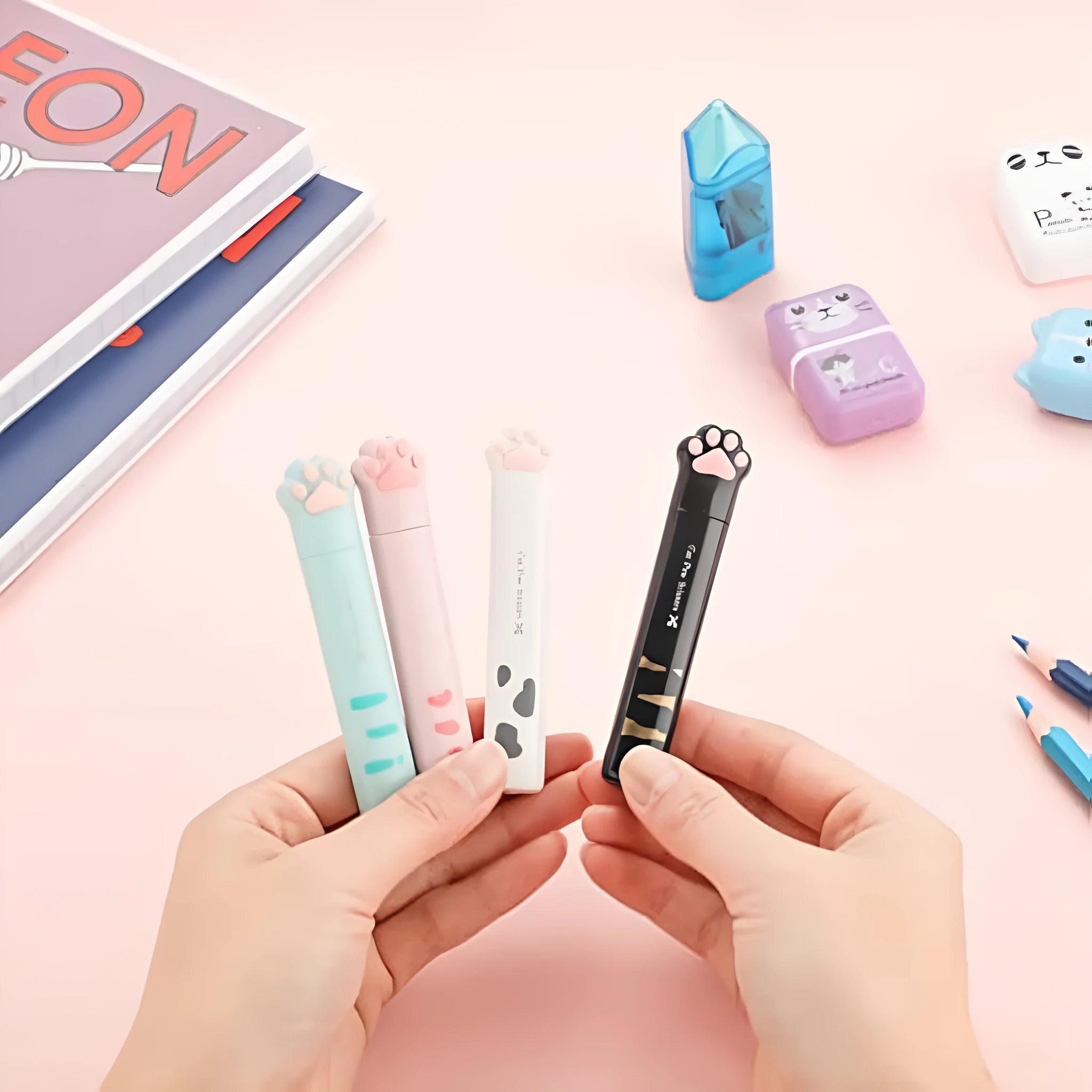 Cat paw mini folding scissors showing stainless steel blades and four colour options: pink, white, black, and blue