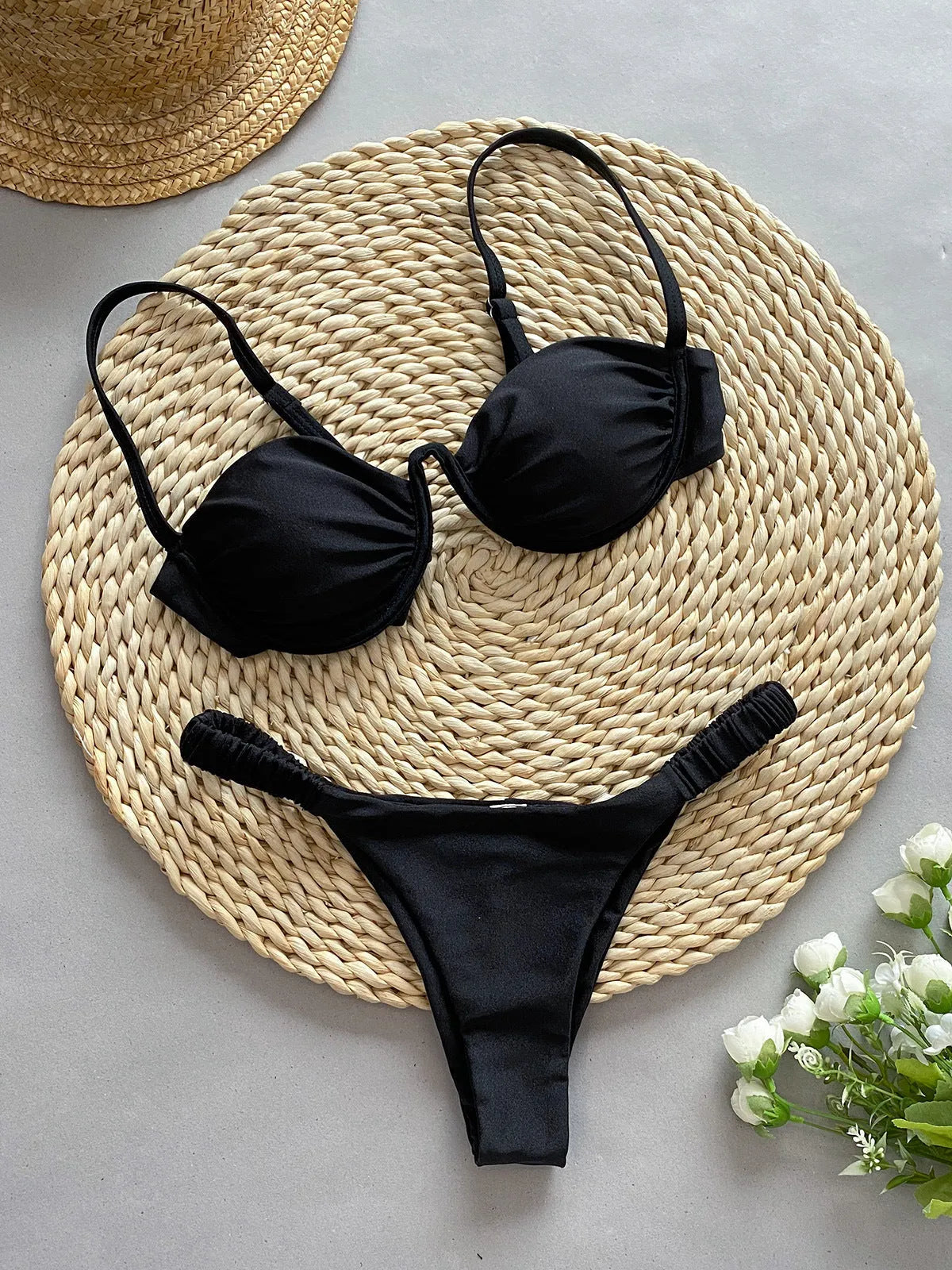 Women's black underwire bikini swimsuit with split briefs, shown on mannequin