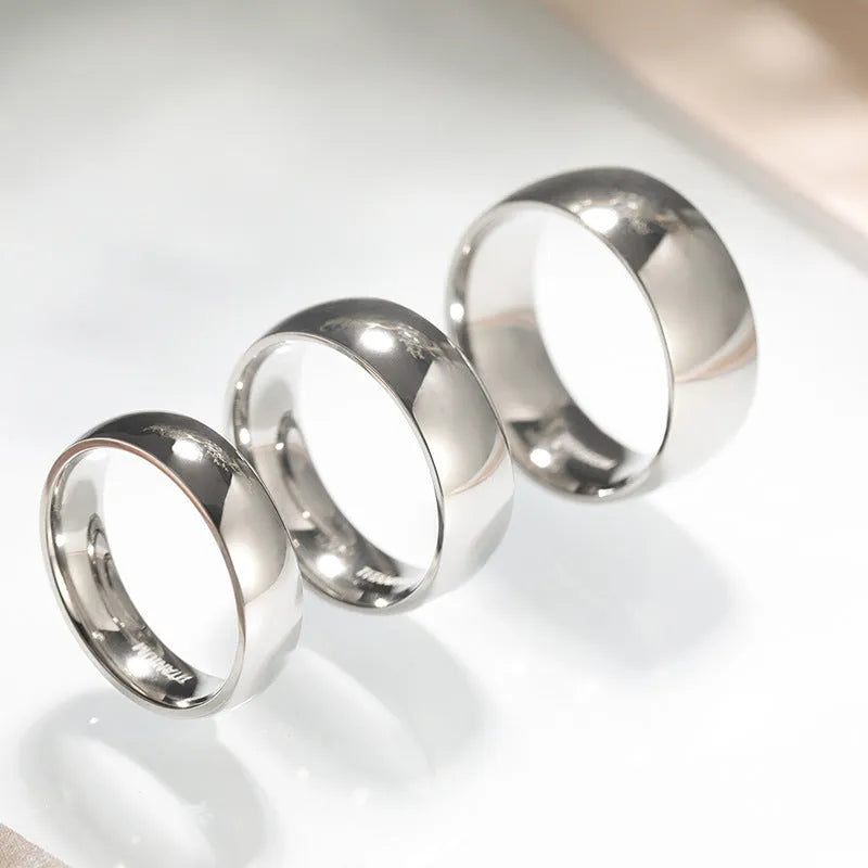 A silver-coloured titanium steel ring shown in a minimalist style on a grey background.