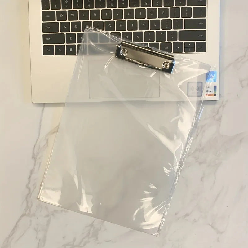 A4 transparent plastic writing board pad with metal clip in blue colour on a desk