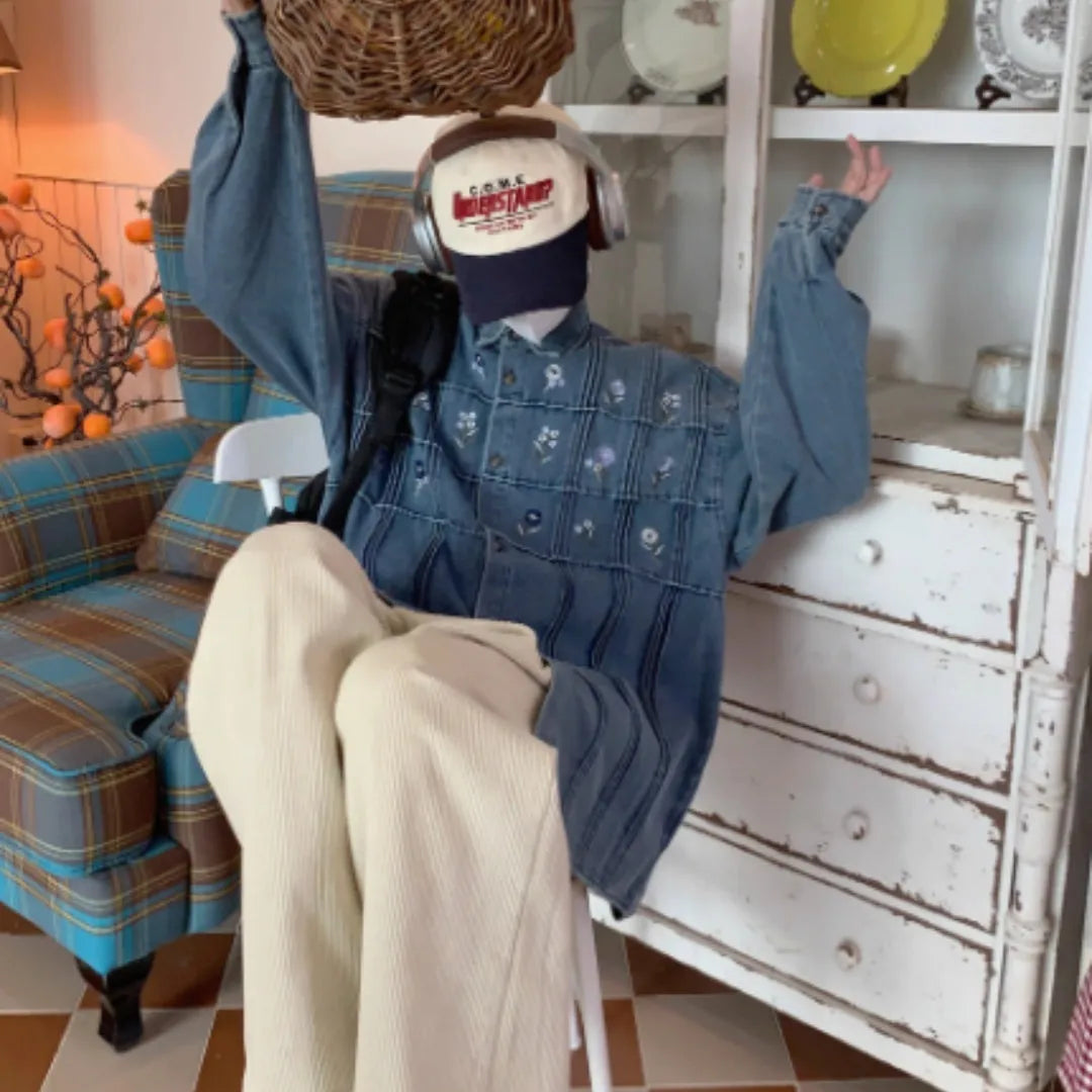 Vintage washed blue denim long sleeve shirt with small floral print and pleated details.