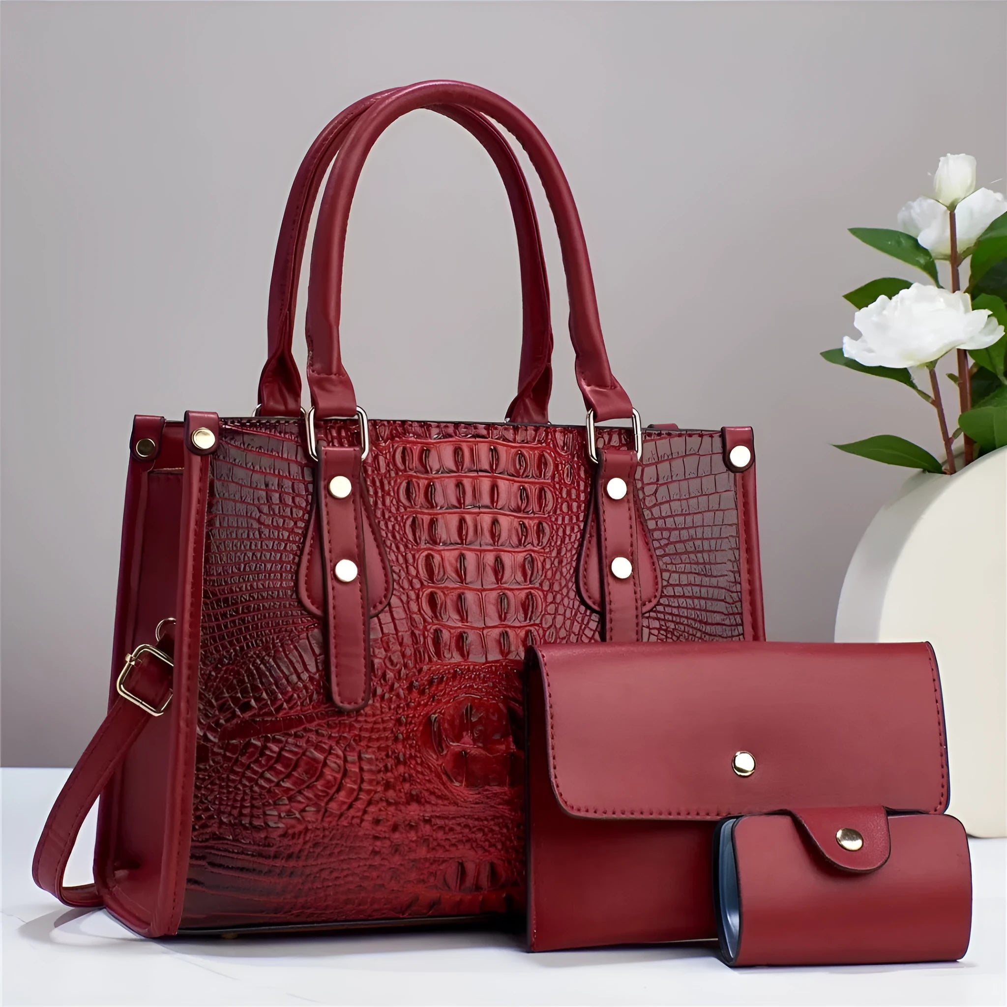Women's burgundy PU leather bucket crossbody bag set with matching wallet and card holder.