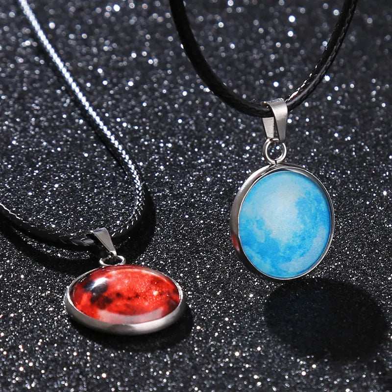 Luminous alloy and organic glass constellation pendant necklace with adjustable chain on white background.