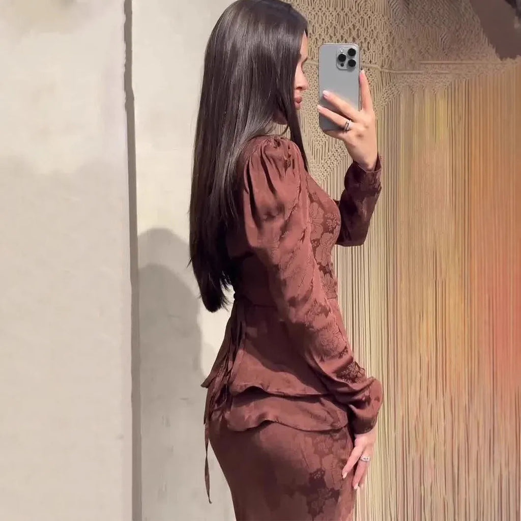 Dark brown long sleeve dress with floral pattern, button details, and a retro fake two-piece style.