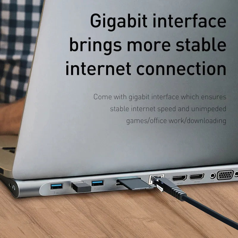 Grey ten-port laptop docking station with integrated cooling bracket showing HDMI, VGA, USB, and Ethernet ports