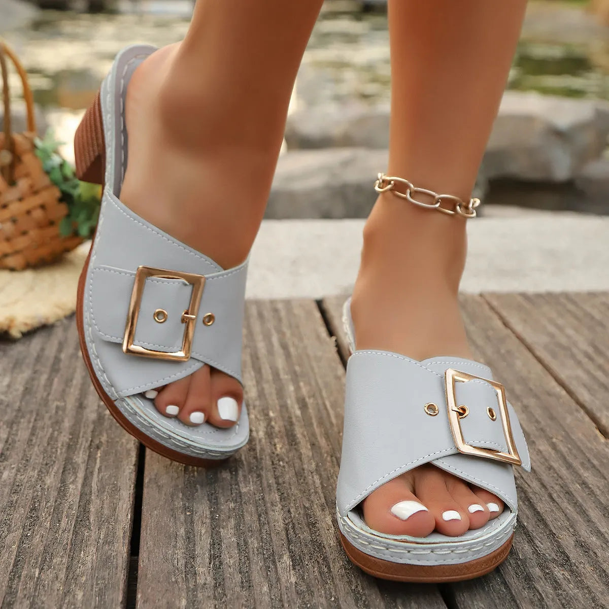 Women's black chunky heel slippers with metal buckle detail and round toe