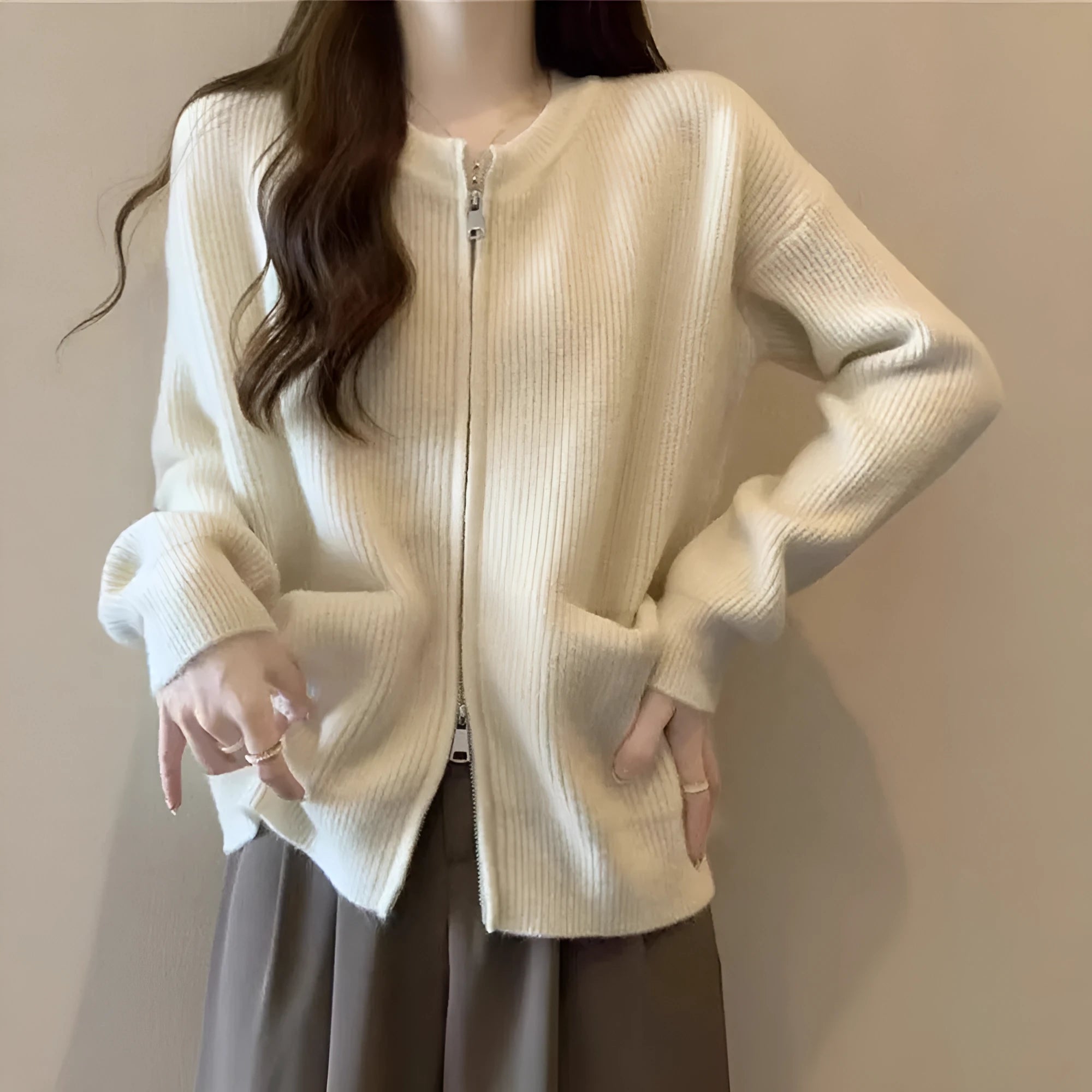 Beige viscose knit cardigan coat with long sleeves on a hanger.