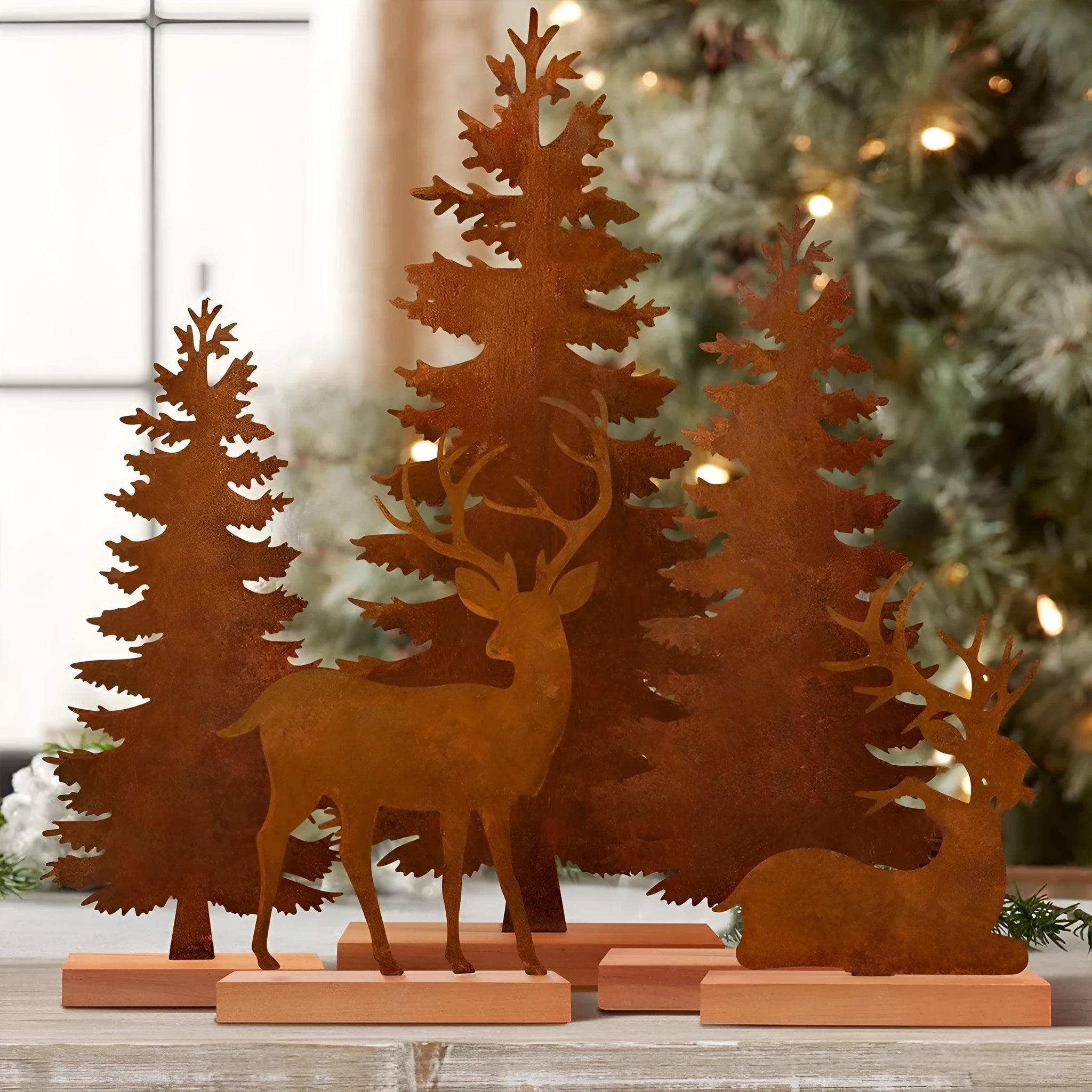Three metal Christmas tree ornaments with elk motifs in rustic patina finish