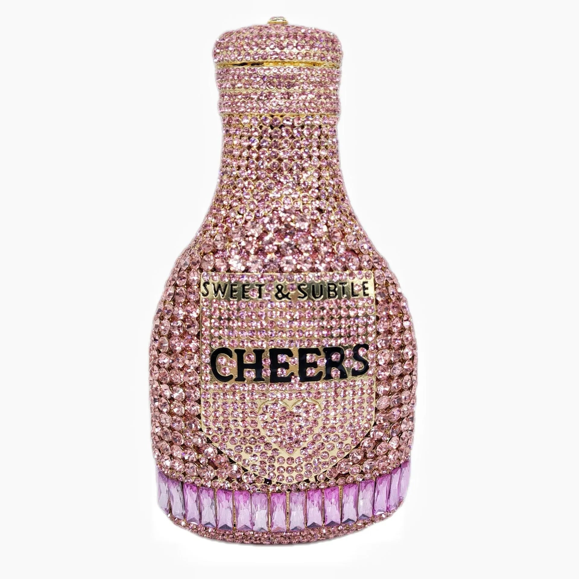 Gold hard-shell champagne bottle shaped evening clutch with rhinestones on a table.