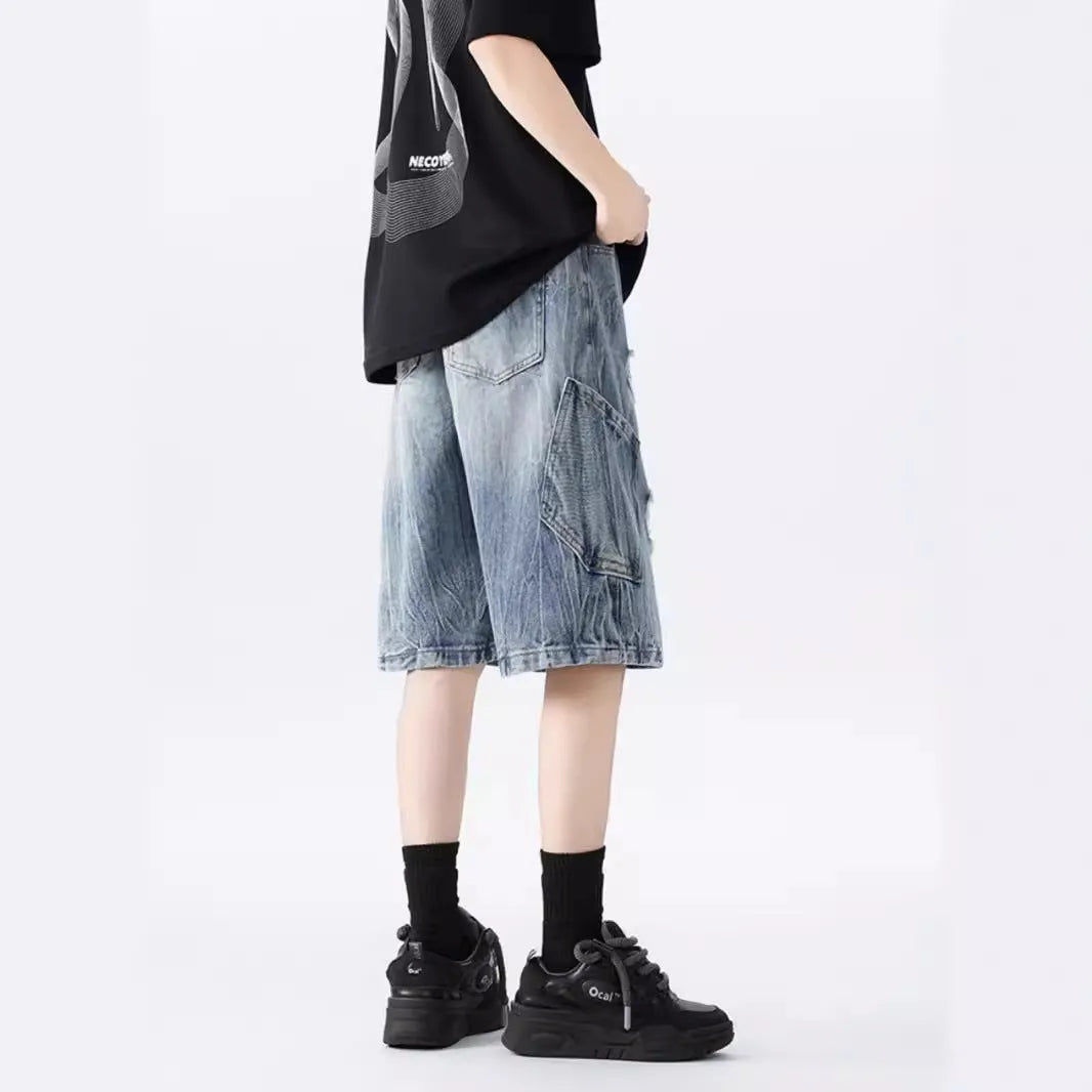 Loose fit ripped denim shorts in black and blue washes on a size chart