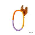 Green circular cotton rope cat toy with feathers and catnip for indoor cats
