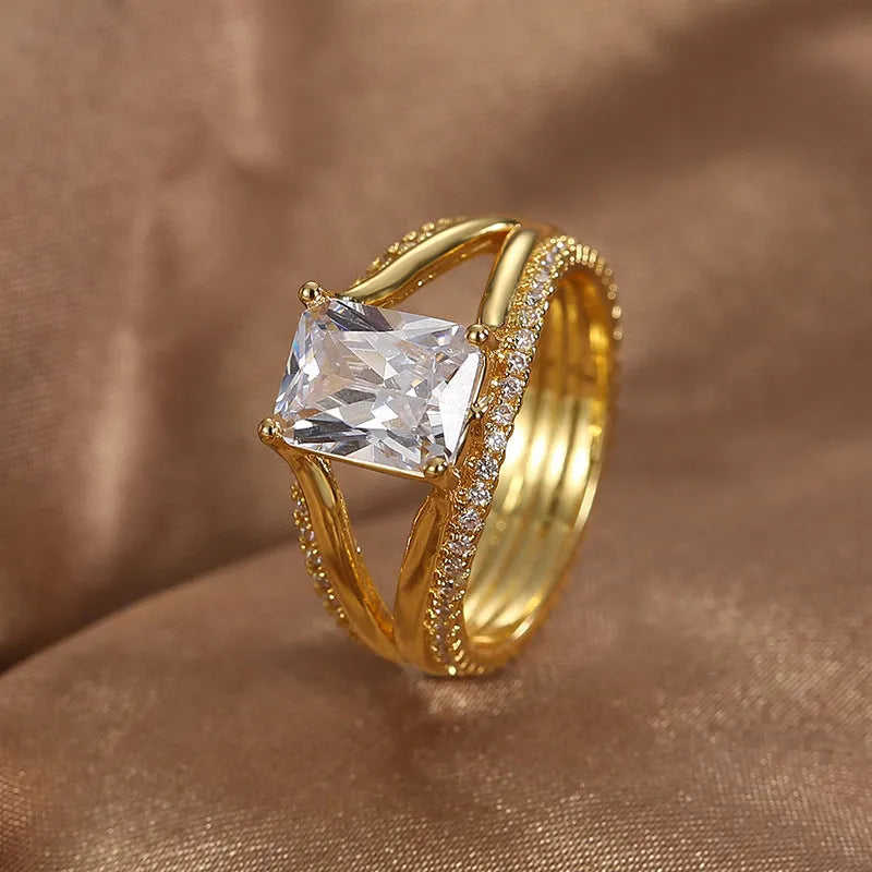 Gold geometric zircon ring for women on a plain background, showing its electroplated copper construction and minimalist design.