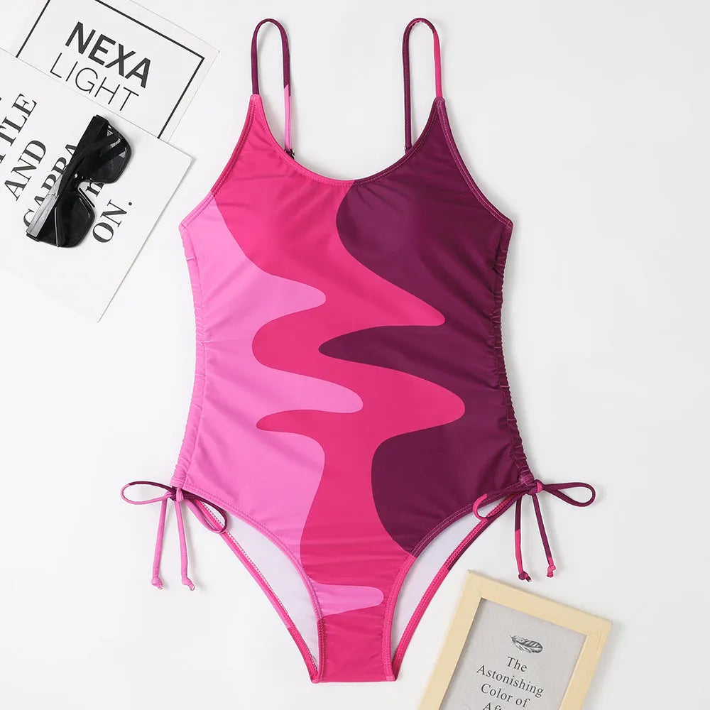 Women's sleeveless backless one-piece swimsuit in blue, shown in a solid colour style.