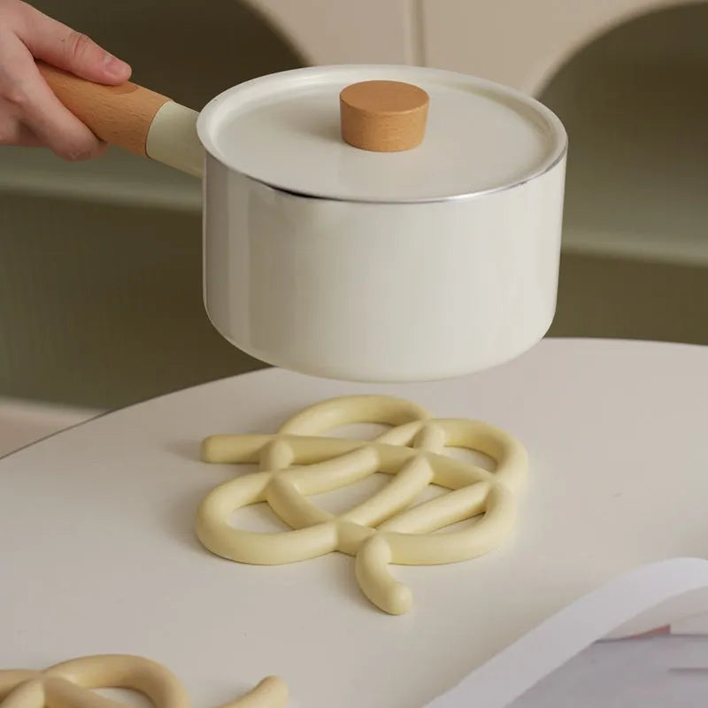 Ceramic heat proof mat in irregular shape on dining table surface