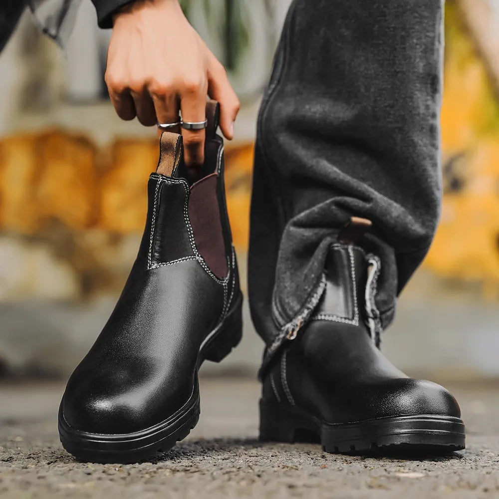 Vintage frosted brown leather Chelsea boot with round toe and low heel on a wooden surface.