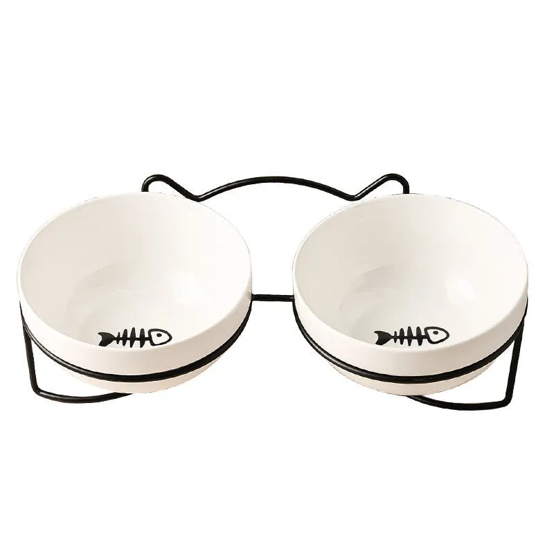 White ceramic cat bowl with cat paw print pattern in a black iron cat-ear frame