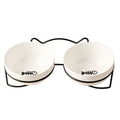 White ceramic cat bowl with cat paw print pattern in a black iron cat-ear frame