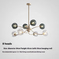 Modern Nordic style multi-head pendant chandelier with green clear lights for a living room.