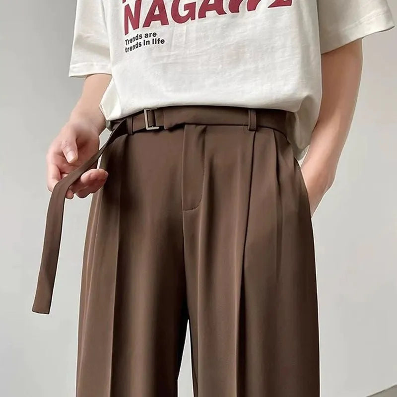 Black thin straight wide leg trousers on a hanger, showing loose fit and straight leg opening.