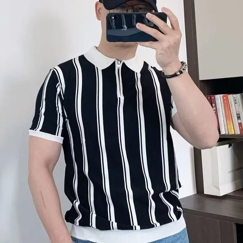 Man wearing a black and white vintage stripe T-shirt with a silver front zipper and cartoon graphic.