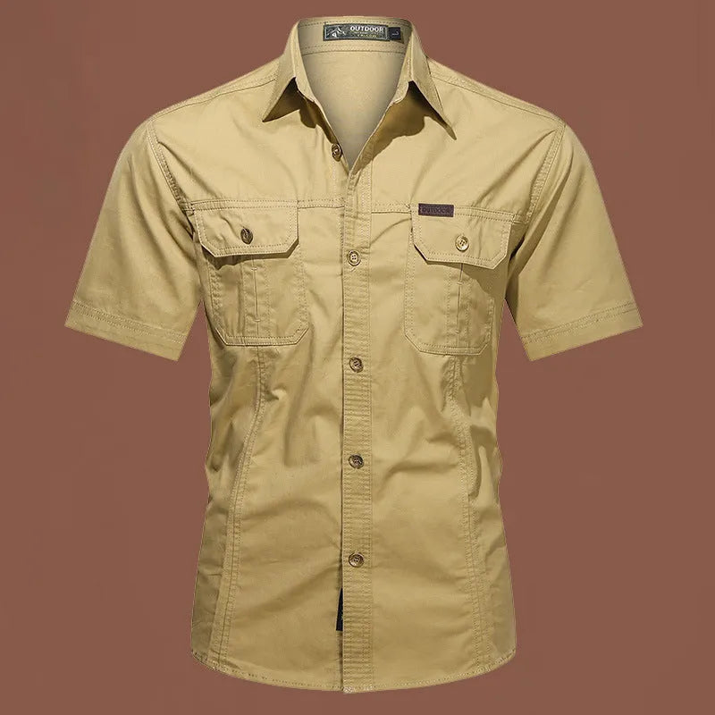 Men's army green cotton work shirt with short sleeves and a loose, non-iron fit.