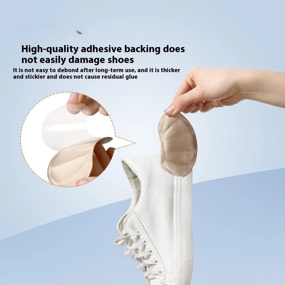 Camel-coloured suede anti-blister heel cushion pads with adhesive backing.