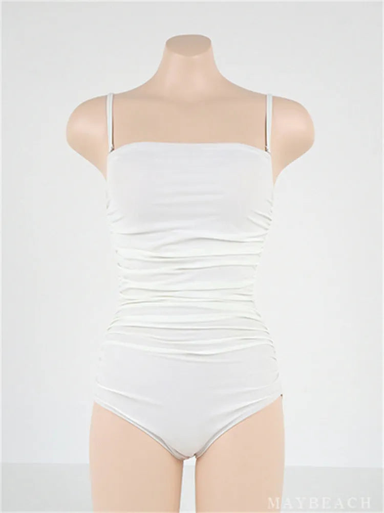 Blue sling style one-piece swimsuit with belly pleats on a mannequin, showing slim-fit design