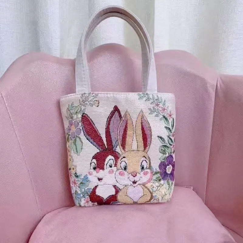 Canvas handbag with gold wire embroidery in floral and illustrative designs