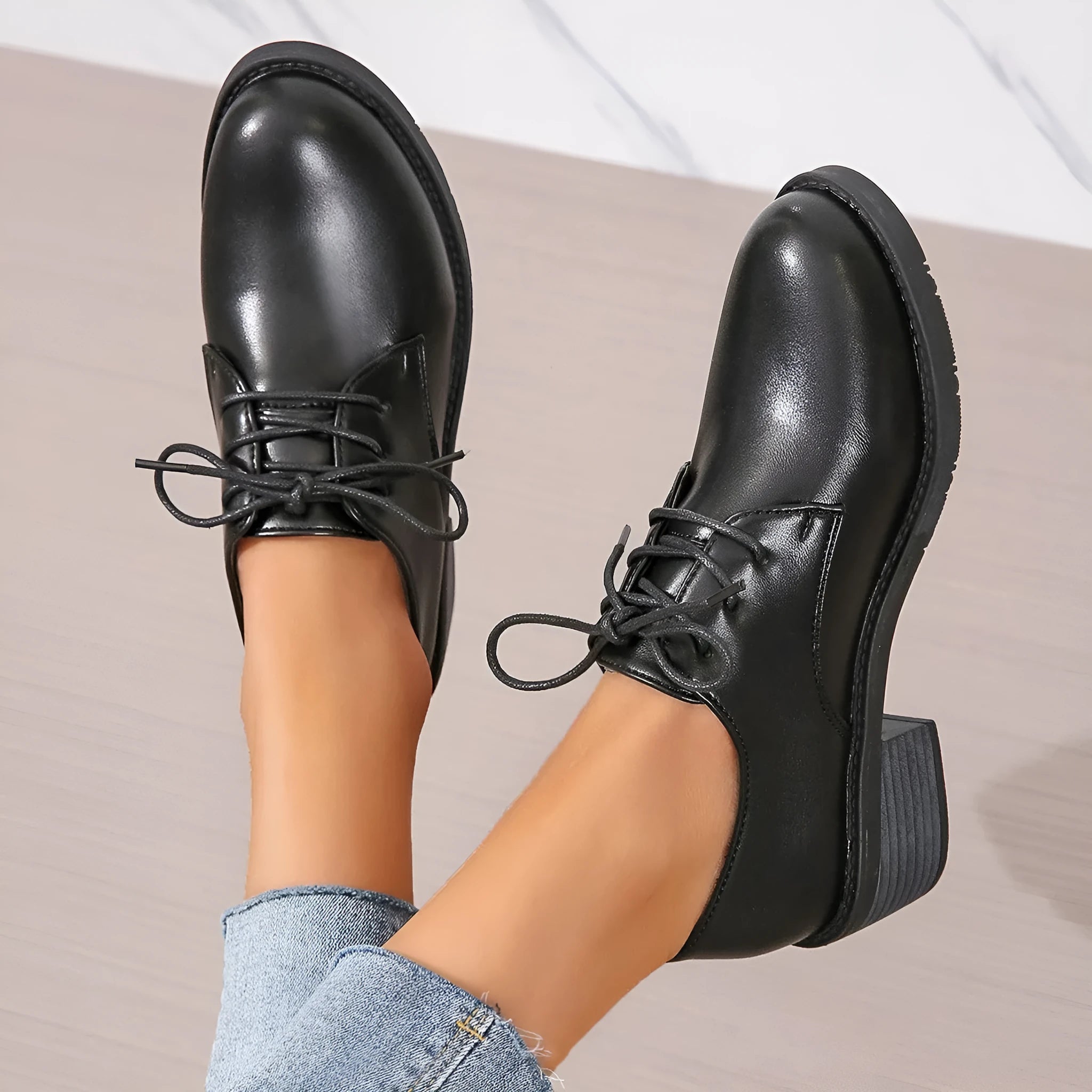 Black women's low-top work shoes with a chunky mid-heel and rounded toe.