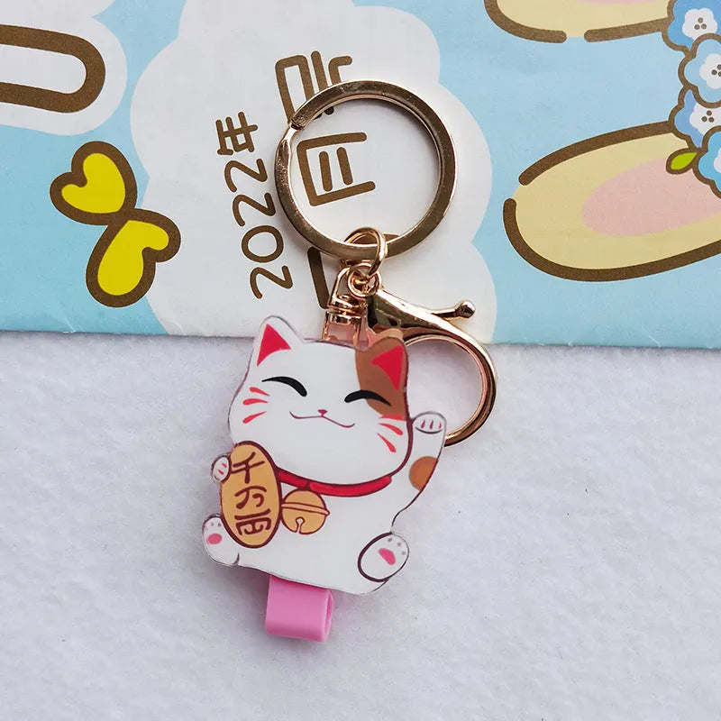 Lucky Cat blessing certificate set showing plastic card sleeve and ferrule pendant in cartoon style.
