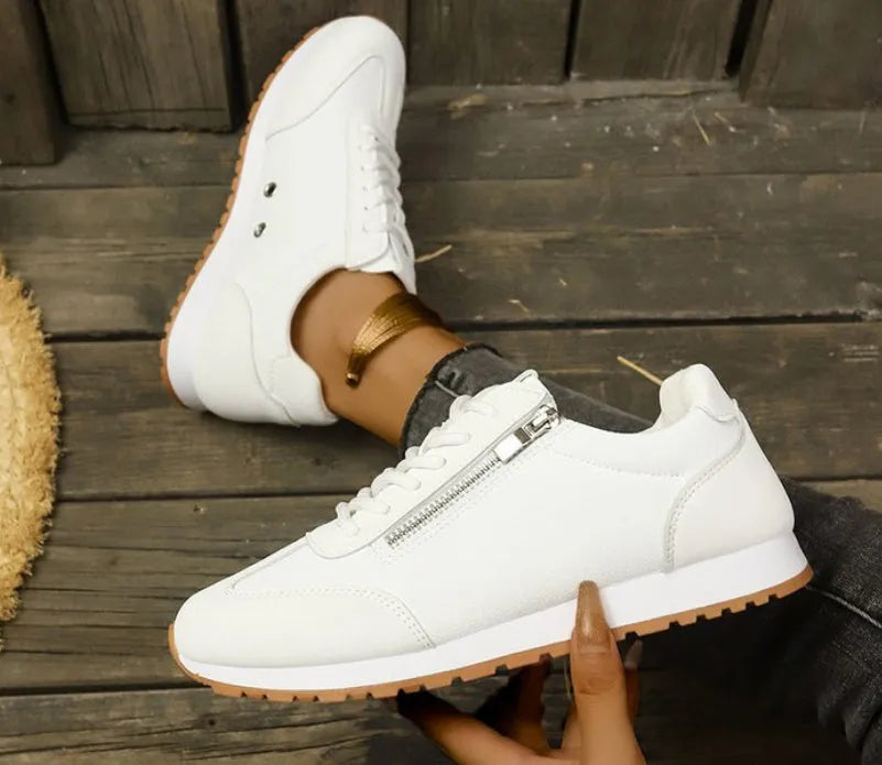 Women's flat-heeled shoes in champagne, grey, and white colours showing lightweight artificial PU uppers and rubber soles