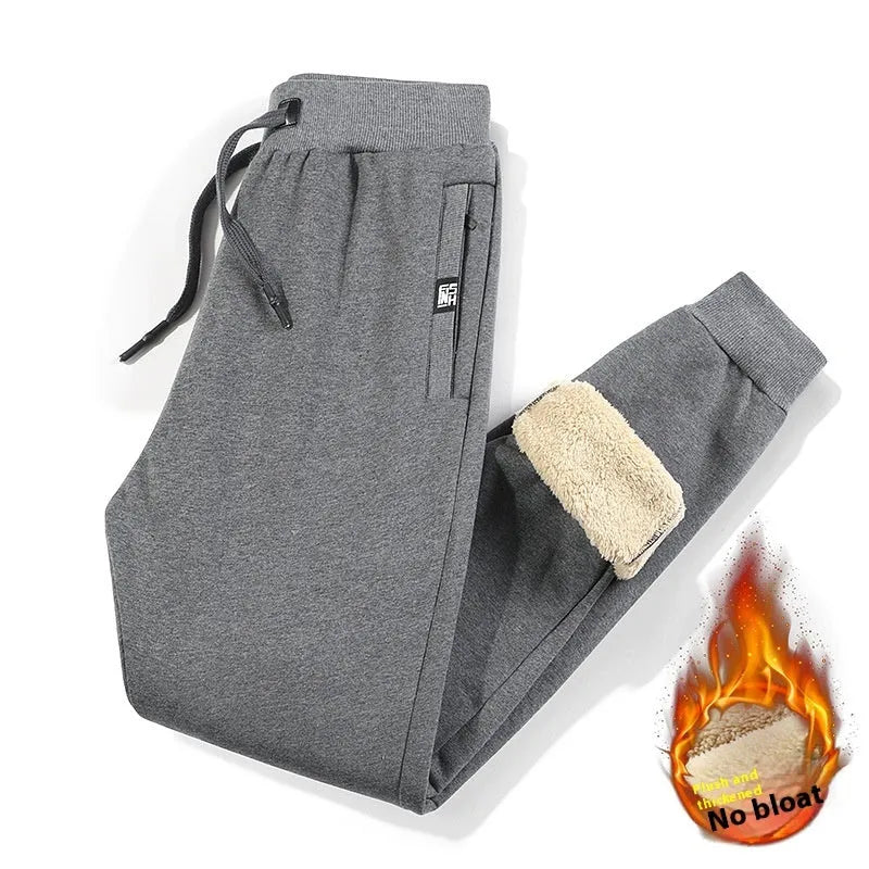 Men's grey fleece-lined oversized cotton track pants on a hanger.