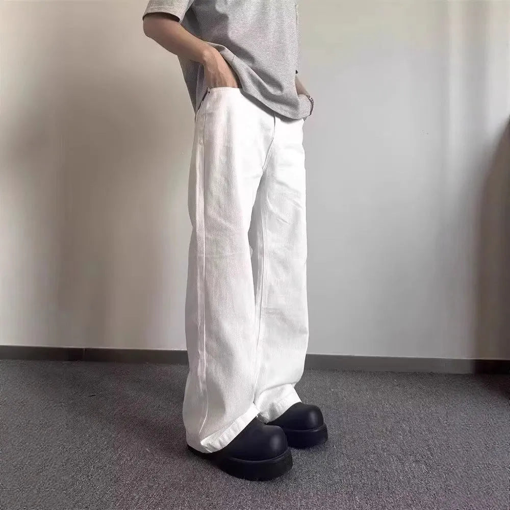 Men's white straight-leg denim jeans with loose wide-leg cut and mid-waist design