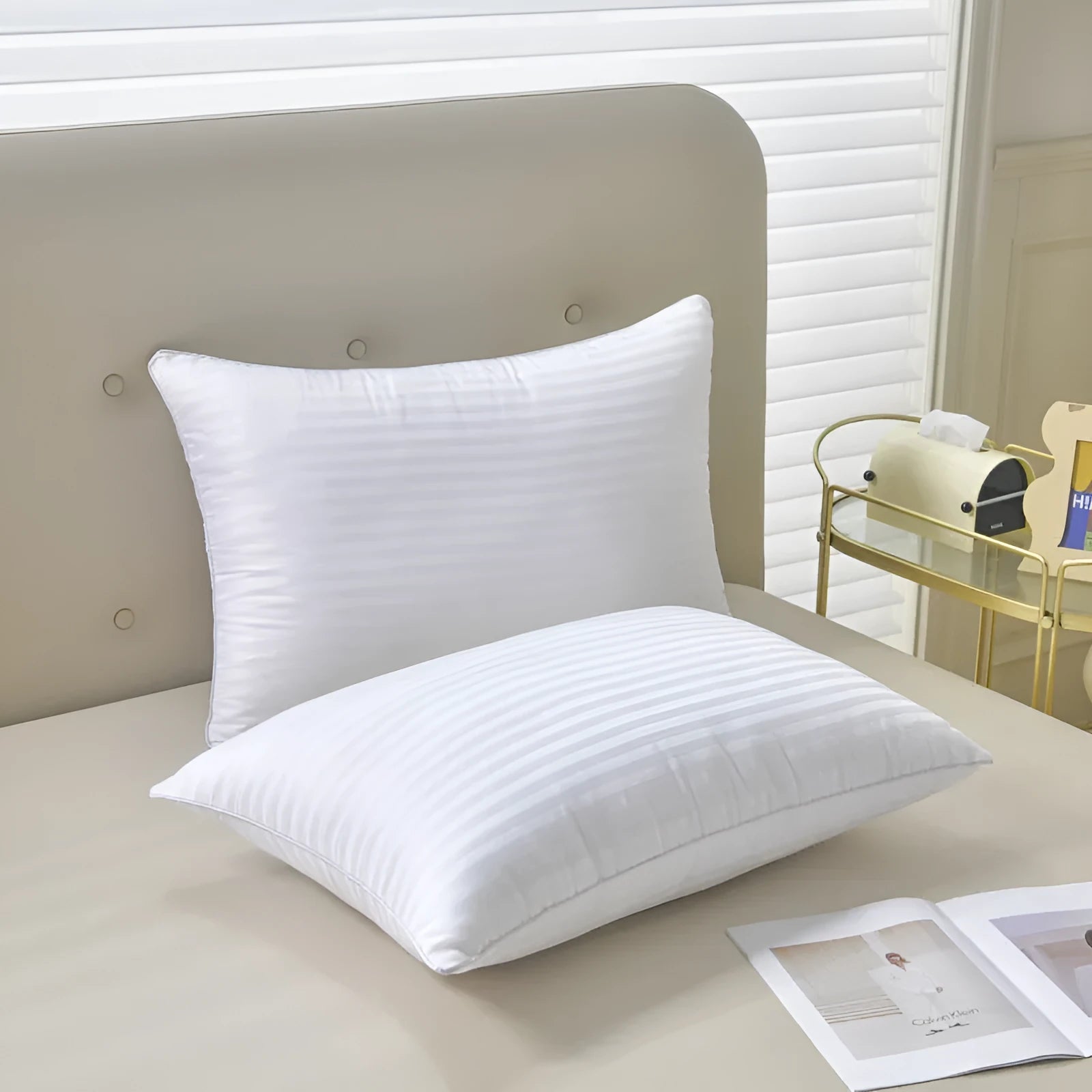 White hotel cotton satin stripe feather and cotton blend pillow showing satin stripe detail.