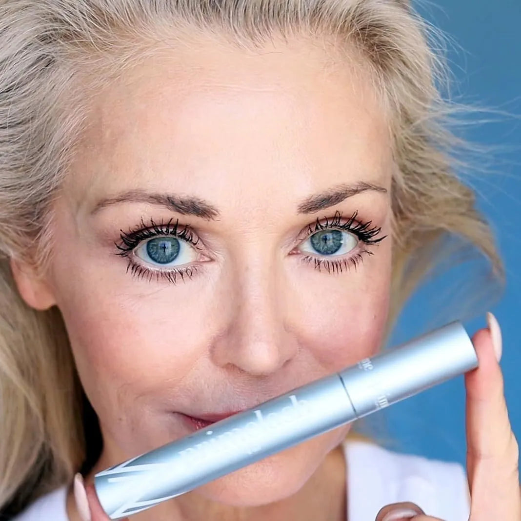 Eyelash brush and comb beauty tool with included eye black product in packaging.