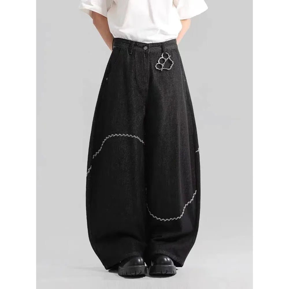 Black straight-leg denim trousers on a hanger, showing mid waist and zip placket detail.