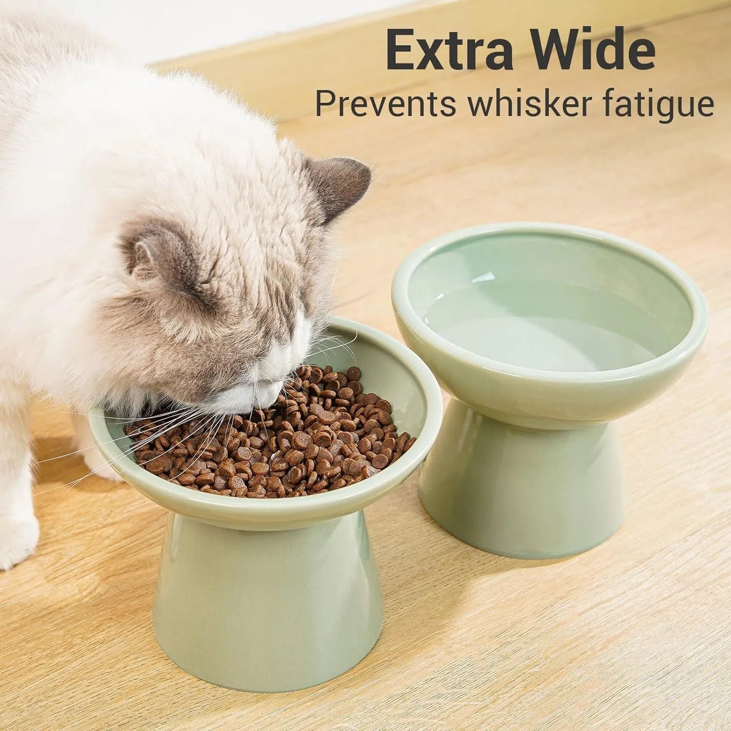 Blue ceramic elevated cat food bowl with wide shallow design next to a matching water bowl.