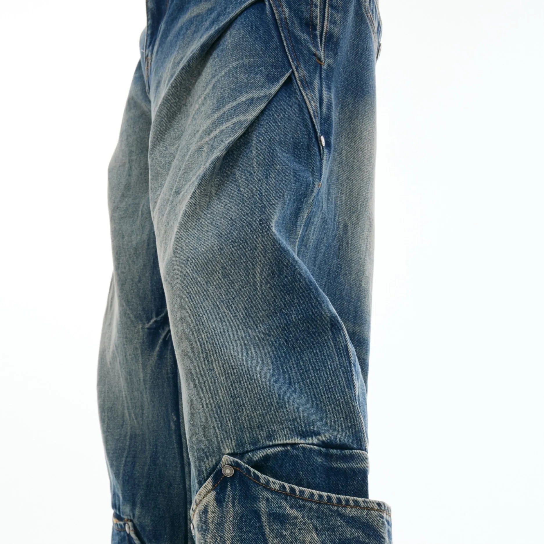 Men's verdant blue loose-fit jeans with a retro washed burst pattern and curved knife leg detail.