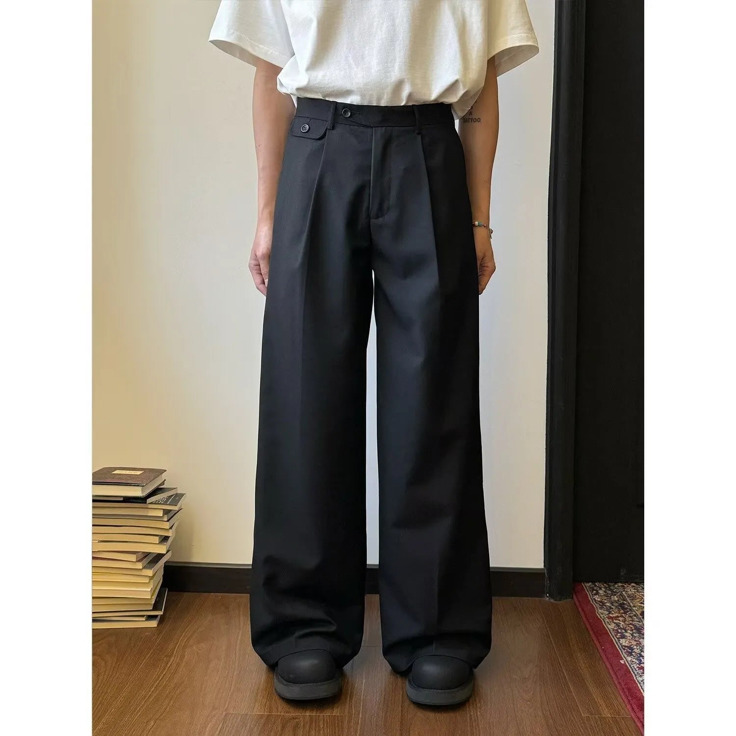Men's brown straight-leg casual trousers with wide-leg drape fit on hanger