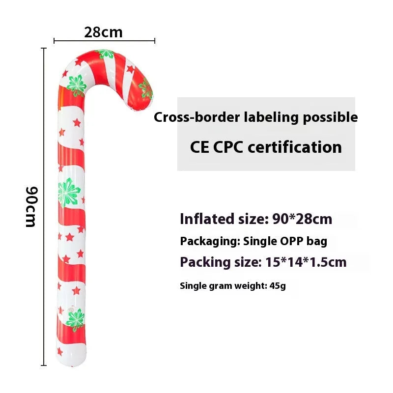 Large red inflatable Christmas ball with snowflake pattern and flash light, shown with a hand pump in a garden setting.
