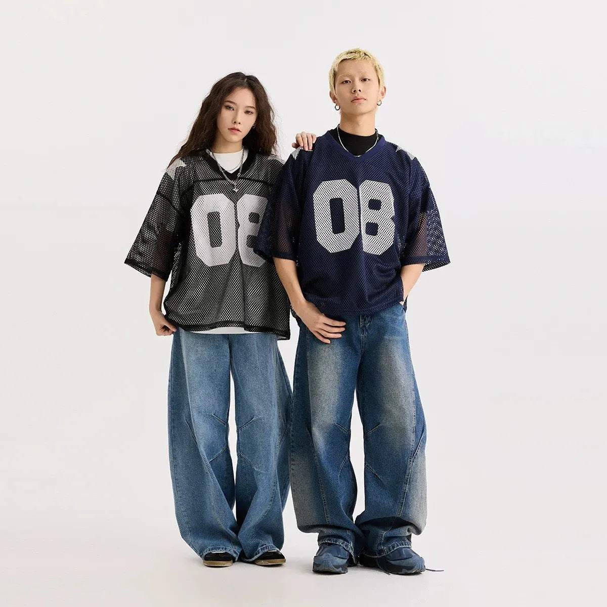 Black loose fit pullover shirt with a white letter pattern across the chest, modelled on a mannequin.