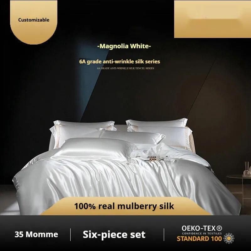 Silk four-piece quilt cover set in a solid colour displayed on a bed, showing the quilt cover and matching pillowcases.