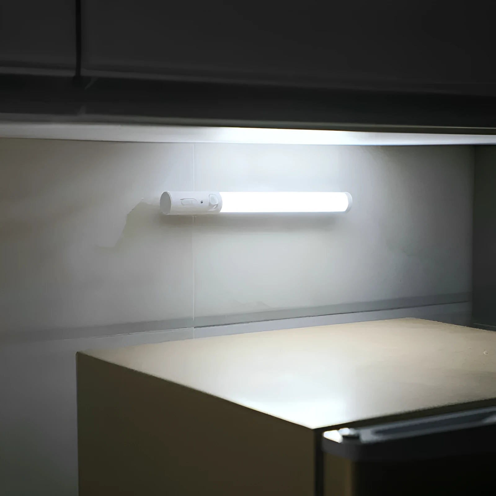 Slim white human body induction LED cabinet light with magnetic strip on back for mounting