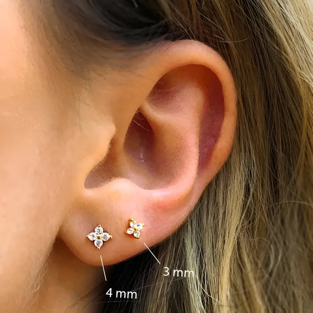S925 sterling silver stud earrings with a small crystal flower design in gold or platinum plating.