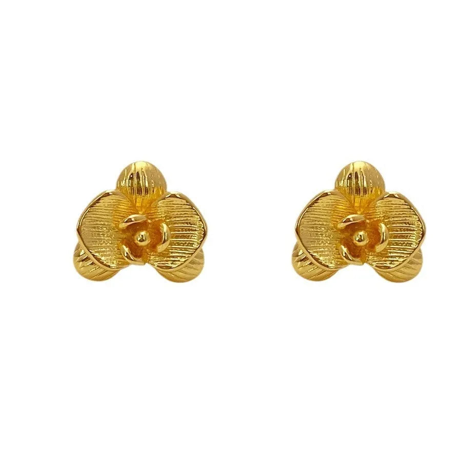 A pair of retro-style copper flower earrings with petal details in a gold electroplated finish.