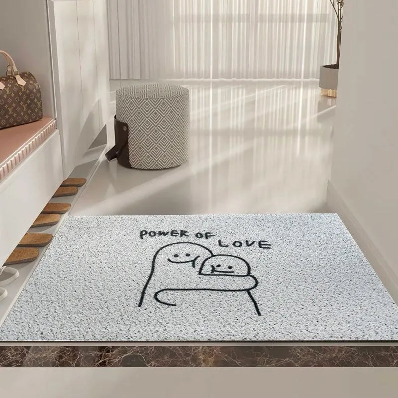 Square PVC floor mat with a large cartoon face and geometric pattern in Mr. Big Nose colours on a home floor.
