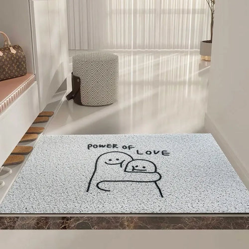Square PVC floor mat with a large cartoon face and geometric pattern in Mr. Big Nose colours on a home floor.