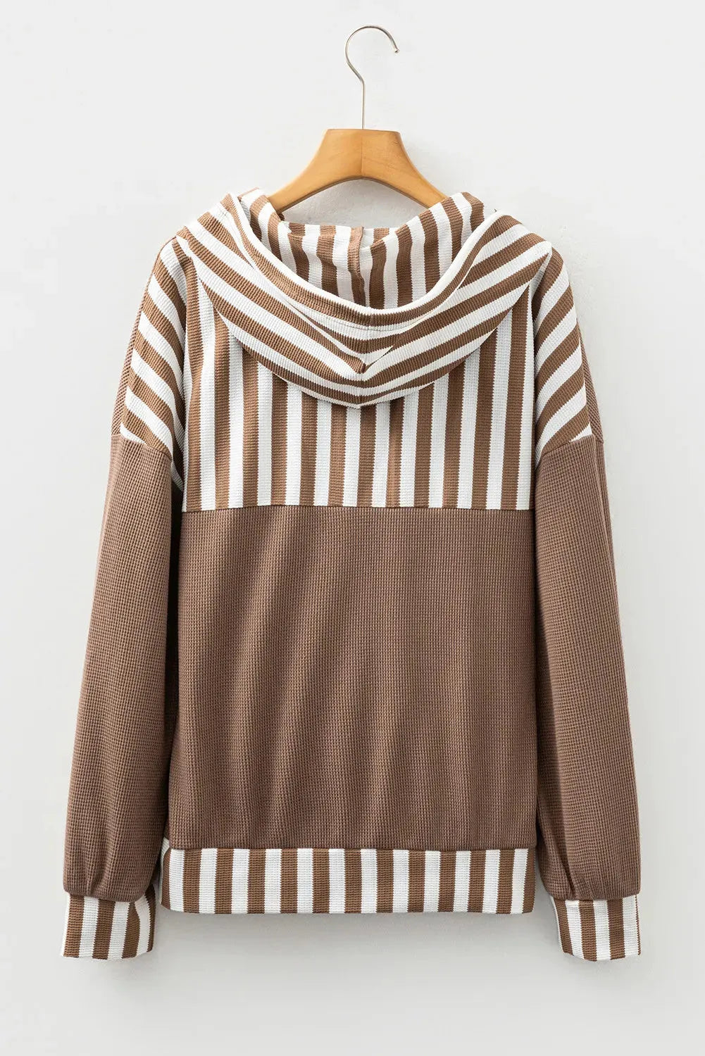 Straw yellow hoodie with waffle texture and striped patchwork design featuring drawstring hood and button neck closure