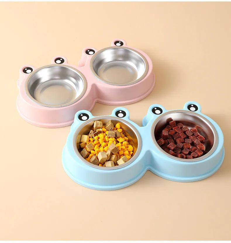 Stainless steel frog-shaped double bowl for pet food and water in blue, green, or pink.