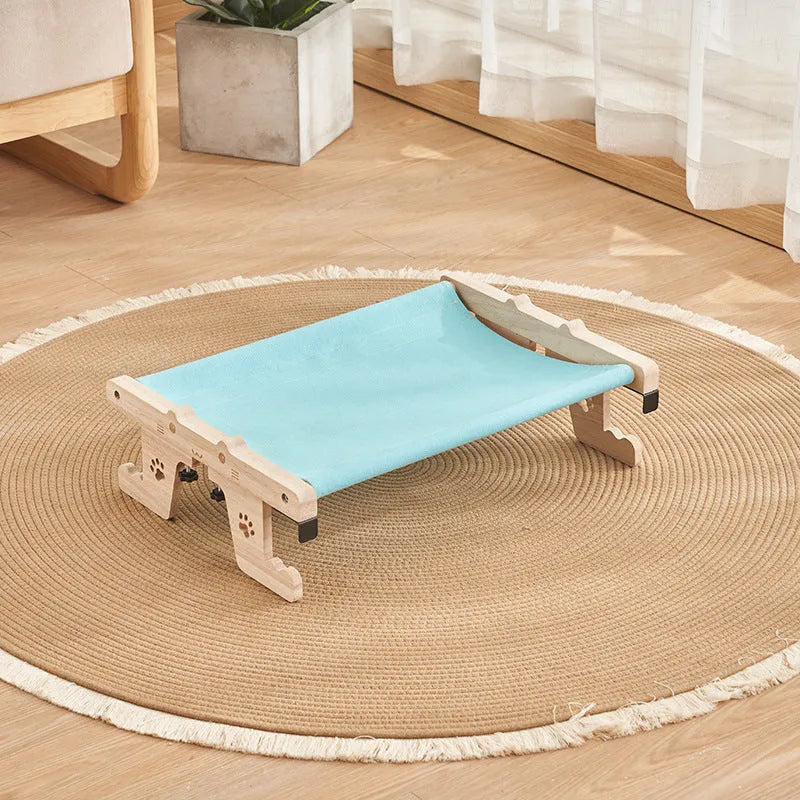 Wooden cat hanging bed hammock mounted on a balcony railing